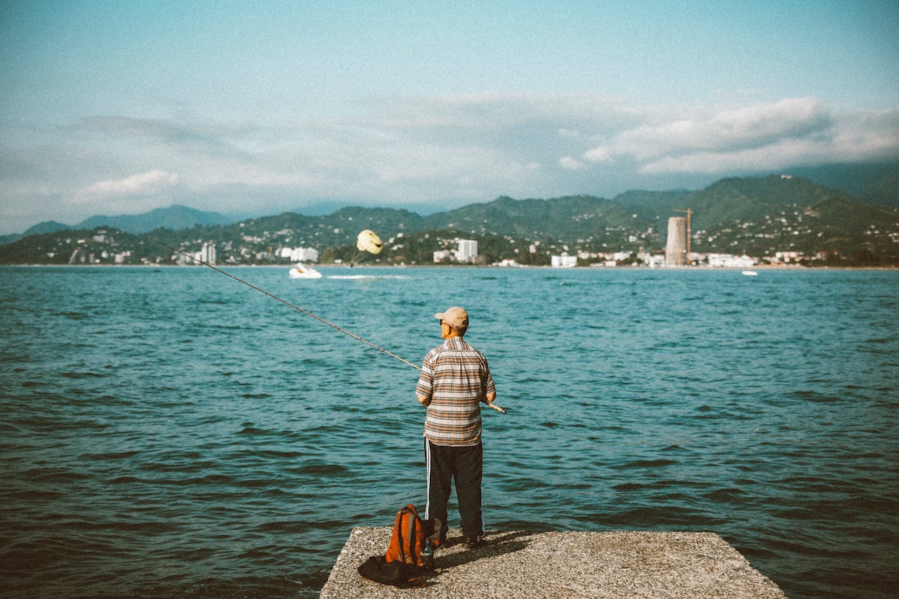 Elderly Man Fishing by the Georgian Coastline